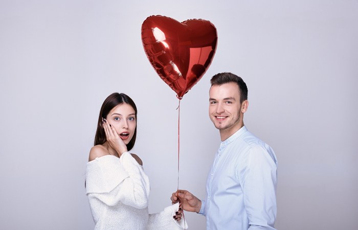 Inflatable or Hydraulic Penile Prosthesis Implant: man and woman holding a heart-shaped balloon together.