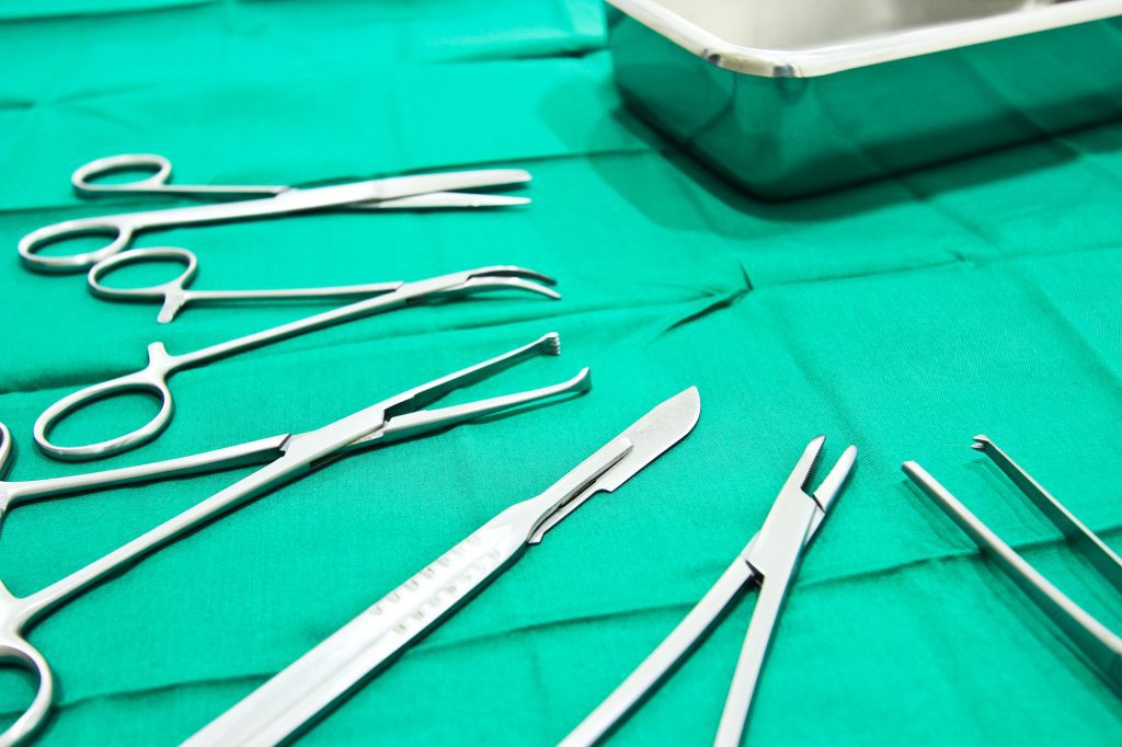 Green surgical towel with silver instruments used for the Modified Nesbit Technique