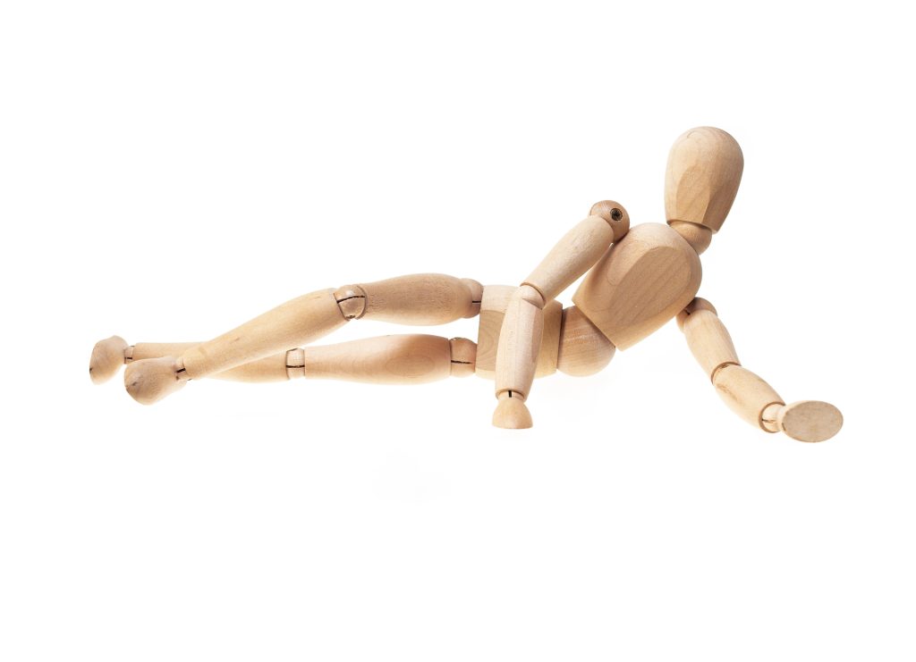 A wooden doll on a white background simulating suitable sexual positions for each type of small penis