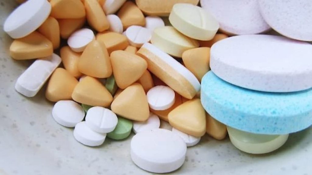 oval, round, triangular, large and small tablets arranged on a flat surface.